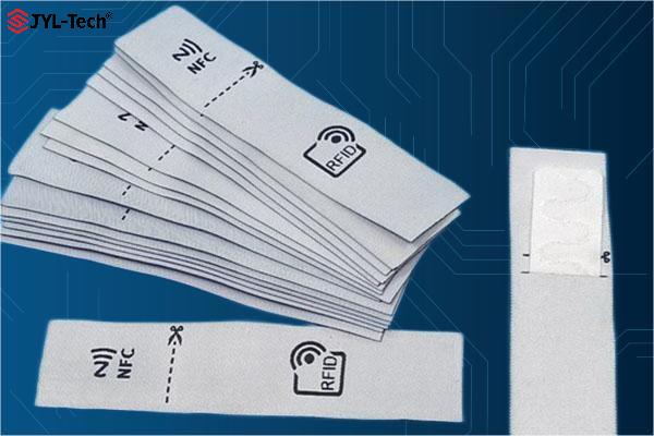 JYL-Tech Dual Frequency RFID laundry tag, including dual frequency RFID washable tag with NFC + UHF chip, either integrating the two frequencies chips in one tag, or separately packaged in two rooms of one pouch, which customers can cut off the UHF part after the garment using.